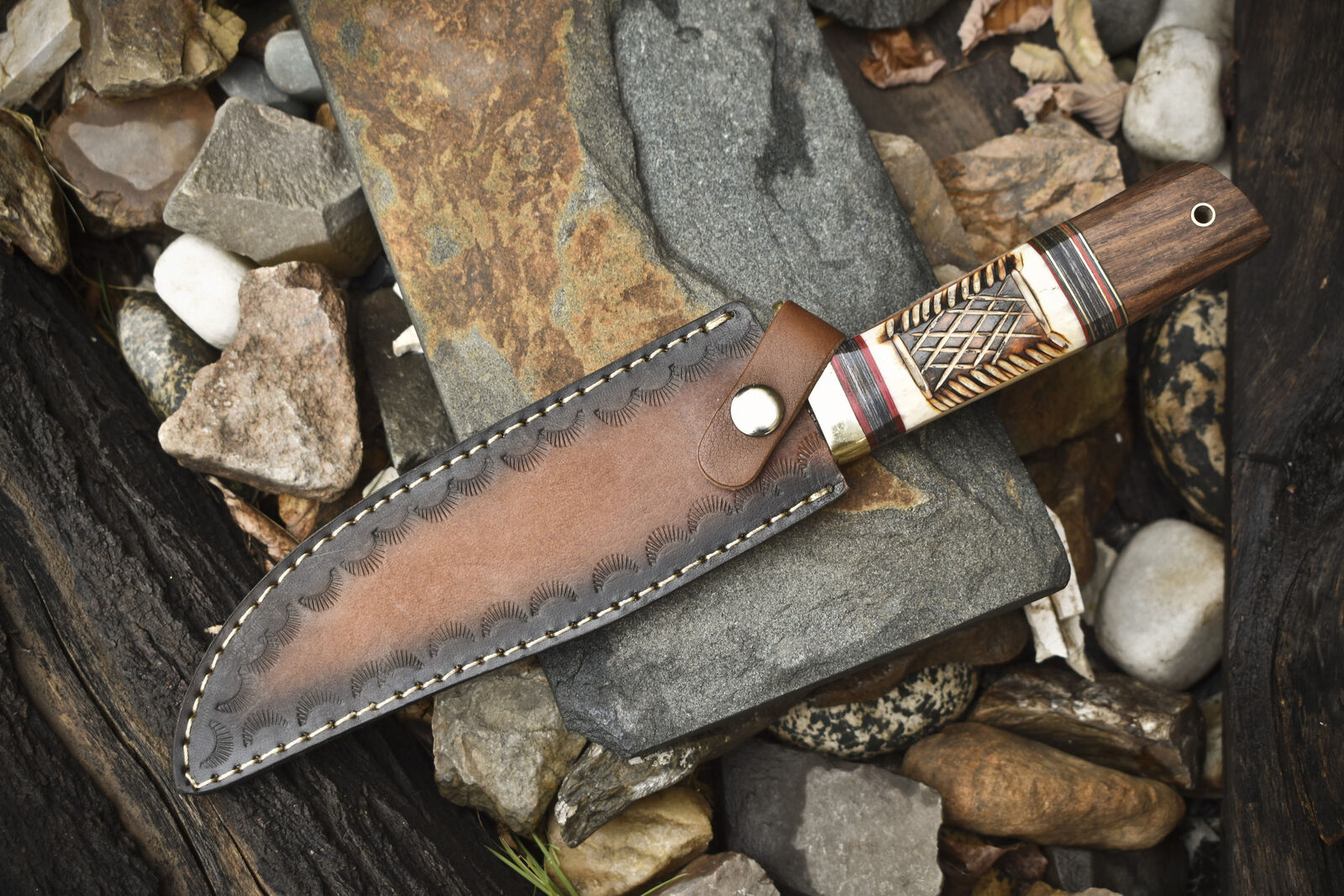 Hand-forged Damascus steel Bowie knife with leather sheath, brass guard, and camel bone rosewood handle