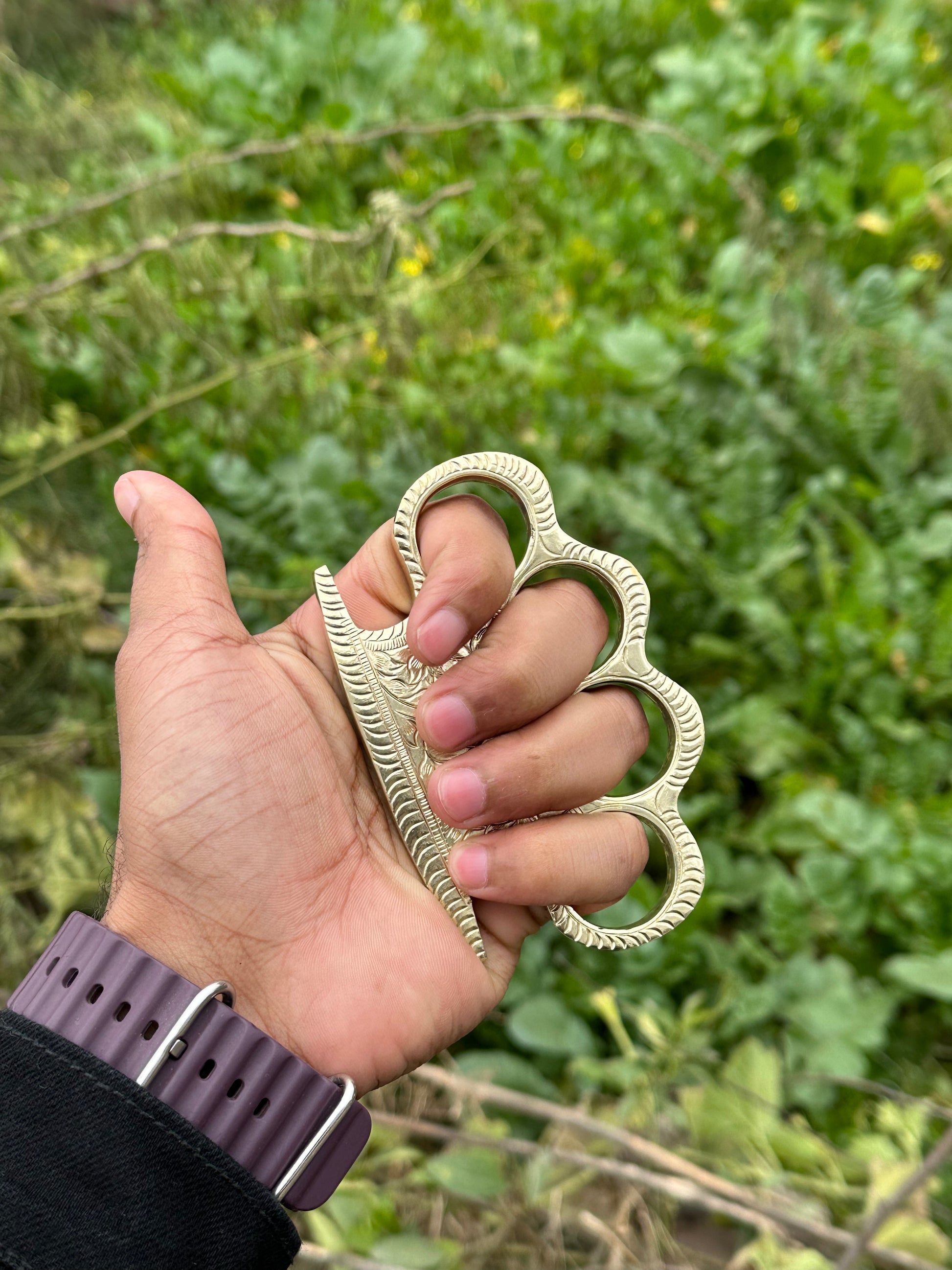 Handcrafted brass knuckle with custom engraving and secure leather belt loop case