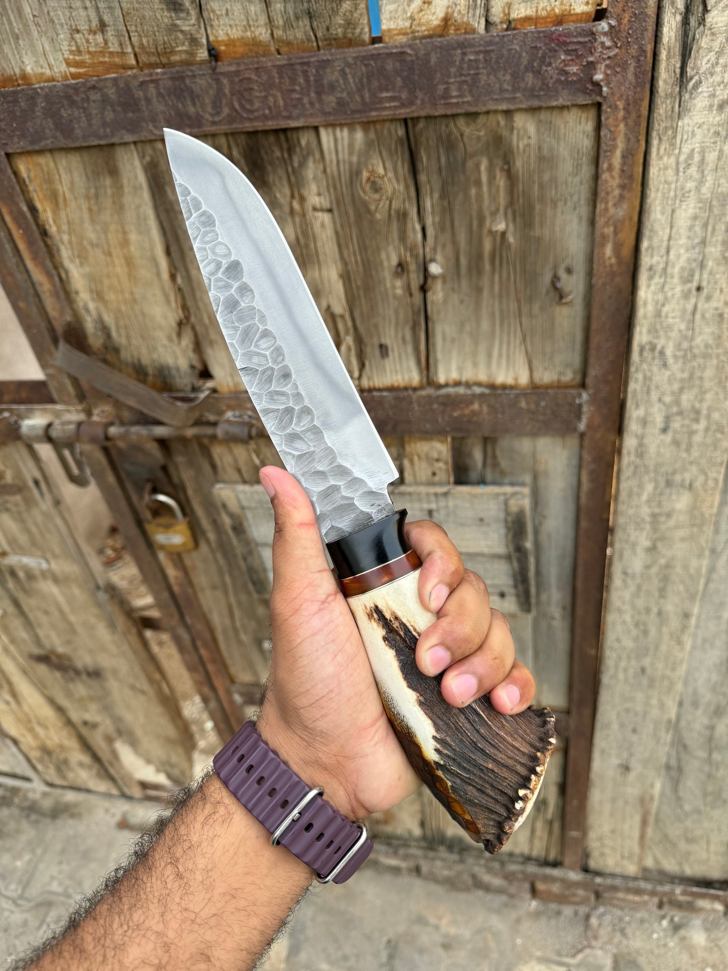 Handmade D2 steel Bowie knife with a 13-inch blade, stag crown handle, and a classic leather sheath for outdoor use