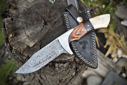 Handmade Damascus steel hunting knife with pakkawood and camel bone handle, includes leather sheath.