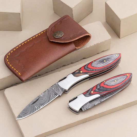 Handmade Damascus steel pocket knife with pakkawood handle and steel bolster.