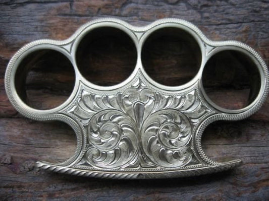 Handmade custom brass knuckle with intricate engravings and a leather belt loop case for secure carrying