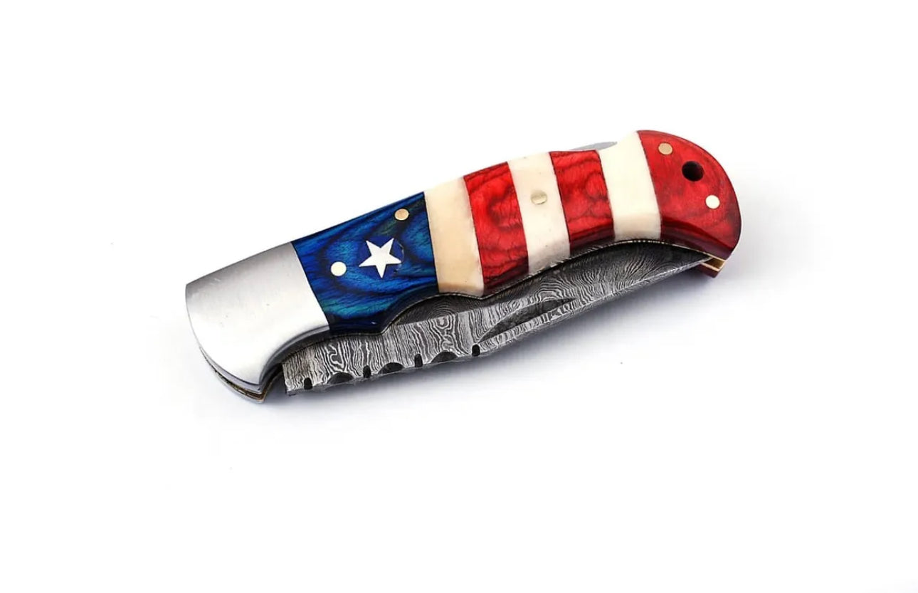 Patriotic Damascus folding knife with a 3-inch blade, American Flag handle, steel bolster, and leather sheath