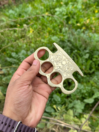 Solid brass knuckle duster with detailed engraving and belt loop leather case