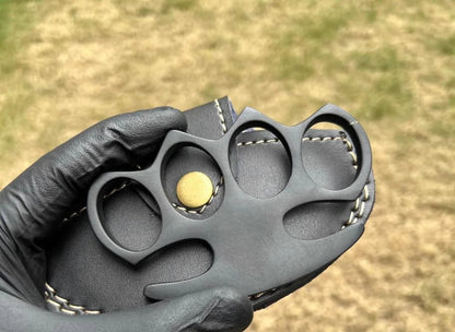 Solid steel knuckle duster in matte black finish with leather case