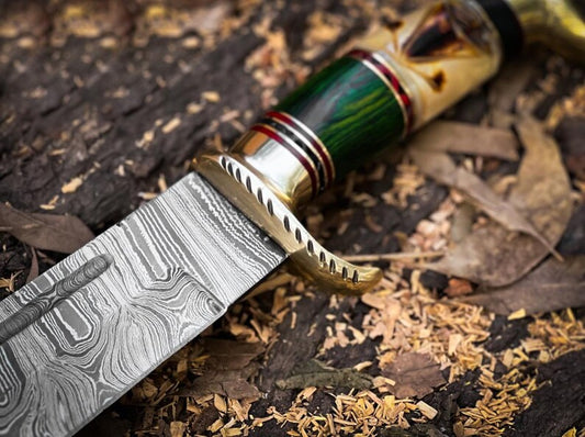 Discover the Damascus Steel Hunting Bowie Knife featuring a brass guard, camel bone, and pakkawood handle. Includes a handcrafted leather sheath. Ideal for hunters and collectors, this knife combines exceptional craftsmanship with rugged elegance.