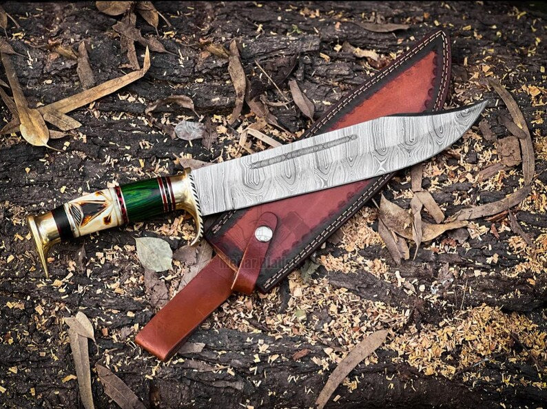 Discover the Damascus Steel Hunting Bowie Knife featuring a brass guard, camel bone, and pakkawood handle. Includes a handcrafted leather sheath. Ideal for hunters and collectors, this knife combines exceptional craftsmanship with rugged elegance.