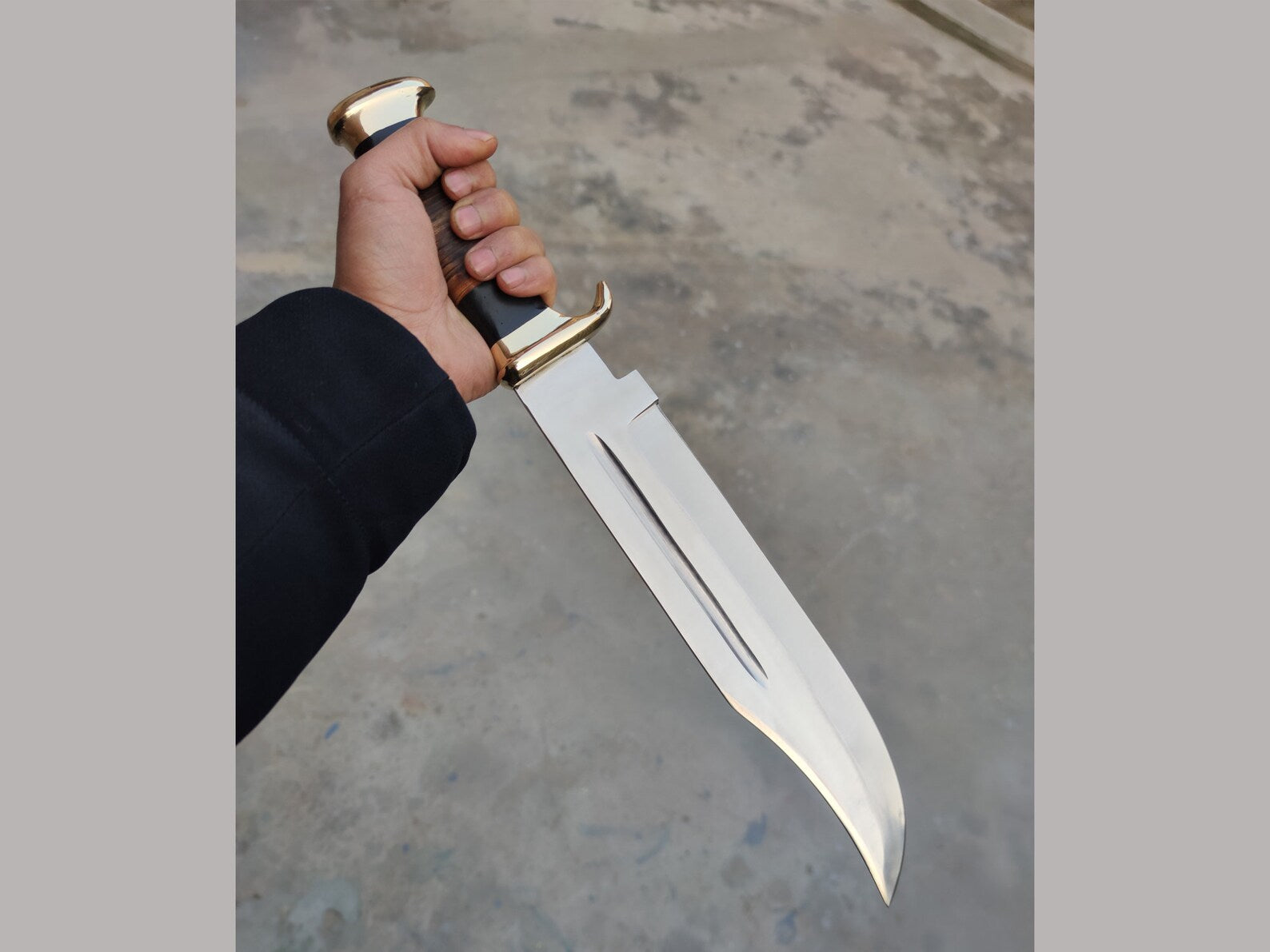 ogan's Crocodile Dundee Bowie Knife with 16-inch 440C steel blade, leather and buffalo horn handle, brass guard, and a high-quality leather sheath