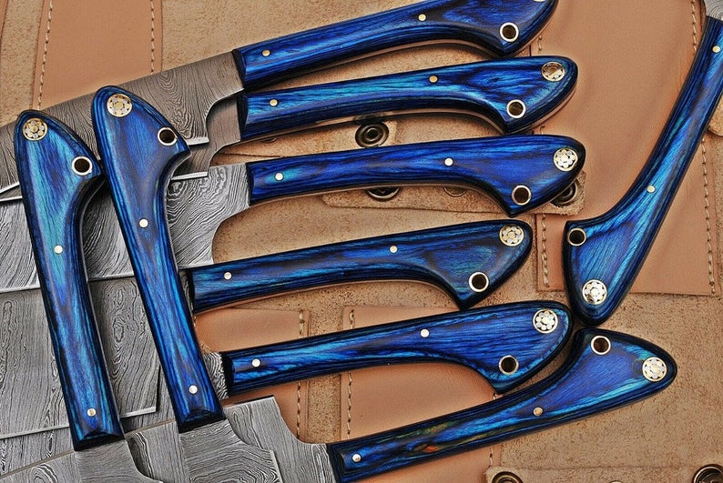 Close-up of a Damascus kitchen knife with an exotic wood handle and intricate twisted pattern blade