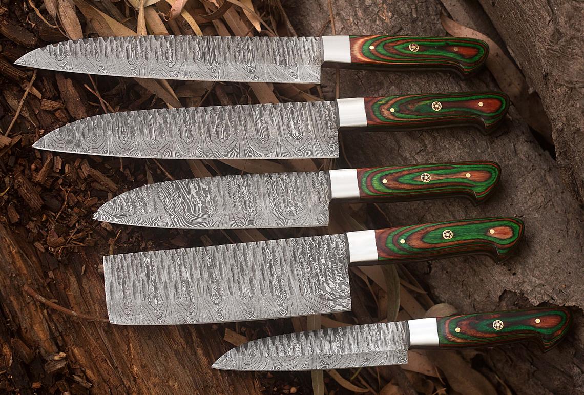 Detailed shot of a twisted pattern Damascus blade and exotic wood handle from a luxury kitchen knife set